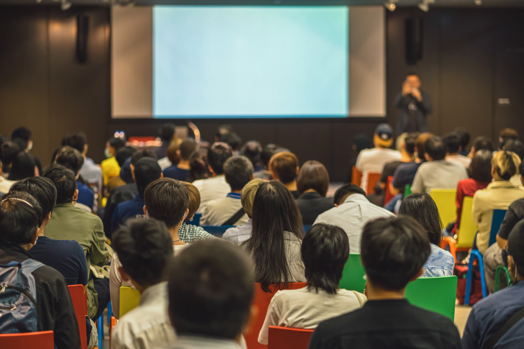 Rear view of Asian audience joining and listening speaker talkin